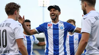 A photo of coach Rik De Mil celebrating with his players after the 0-1 win against IFK Göteborg, with a triumphant...
