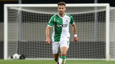 A photorealistic image of an anonymous KAA Gent player in a green and white jersey, with a determined expression, running...